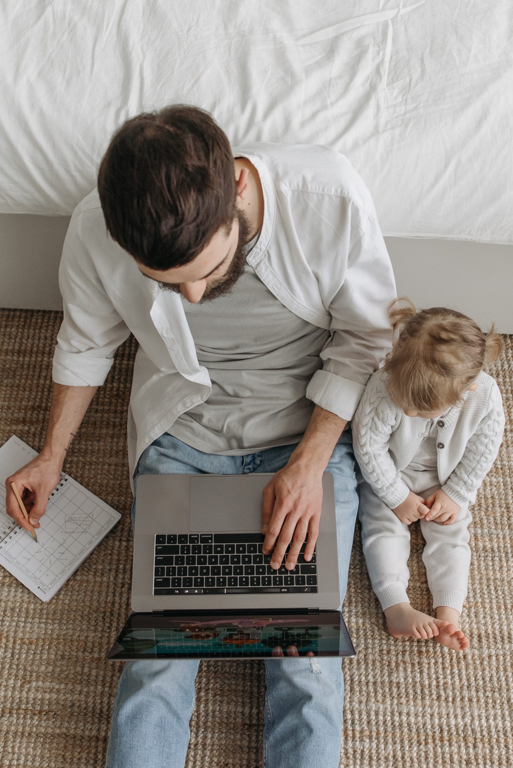 Man on computer with child next to him